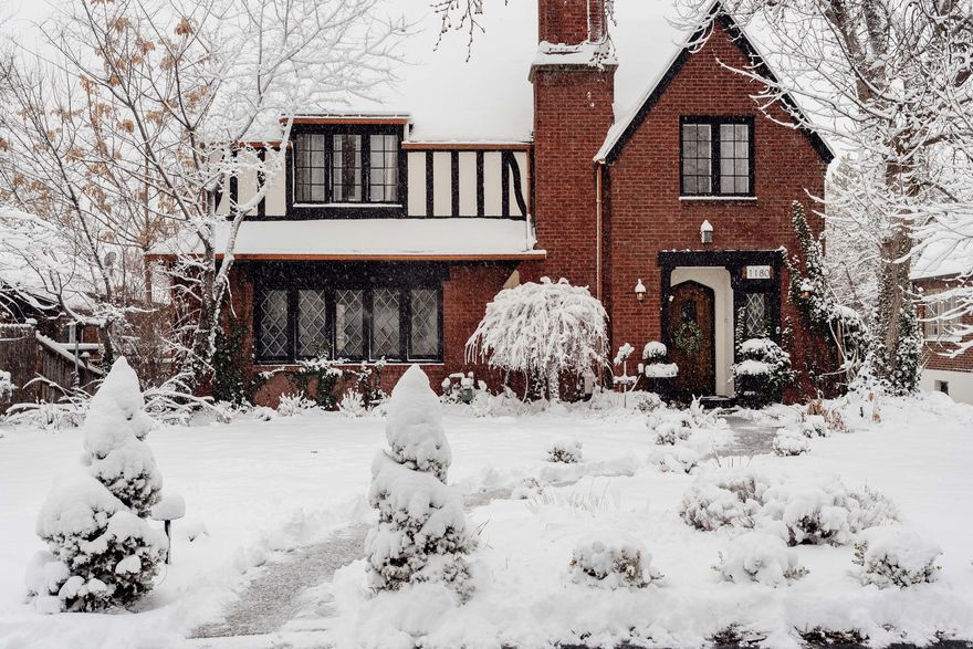 Built in 1926 and beautifully updated over the years, this classic brick Tudor blends original character with thoughtful upgrades in all the right places. Rich original woodwork, graceful architectural lines, and an original fireplace adorned with handmade tile details create that unmistakable old-world warmth, while curated lighting and elevated finishes bring a fresh, contemporary glow. The main level feels both refined and inviting-perfect for gathering, hosting, and everyday living-and includes a convenient half bath for guests. Updated bathrooms throughout the home reflect elevated finishes and thoughtful design, honoring the era while embracing modern comfort. Upstairs, you'll find three bedrooms and two bathrooms, including a spacious and beautifully reimagined primary suite. Generous in scale and filled with natural light, the primary bedroom offers room to truly unwind. A modern, oversized walk-in closet and a private, updated bathroom create a retreat that feels both serene and luxurious-an uncommon and highly coveted find in a 1920s Tudor. Downstairs, the fully finished walkout lower level offers two additional bedrooms, a full bathroom, and a second kitchen-creating an ideal setup for multigenerational living, extended guests, or potential income. With its own access to the backyard, this level truly lives like a separate residence while still feeling connected to the heart of the home. And then there's the bonus. A detached two-car garage-unusual for a home of this age-adds convenience and flexibility. Above it, a stunning vaulted finished space is currently used as a light-filled office but could easily transform into a studio, guest suite, creative retreat, or future ADU. With three bedrooms upstairs, two more in the walkout lower level, and this additional finished space above the garage, the possibilities here are both generous and versatile. The backyard is large, usable, and beautifully designed-rare for this neighborhood and era. Thoughtfully landscaped, it features an outdoor fireplace for cozy evenings, a charming fountain for ambiance, and plenty of room to dine, garden, gather, or simply exhale. In front, custom uplighting elevates the home's stately Tudor faade, giving it a warm and welcoming presence after sunset.