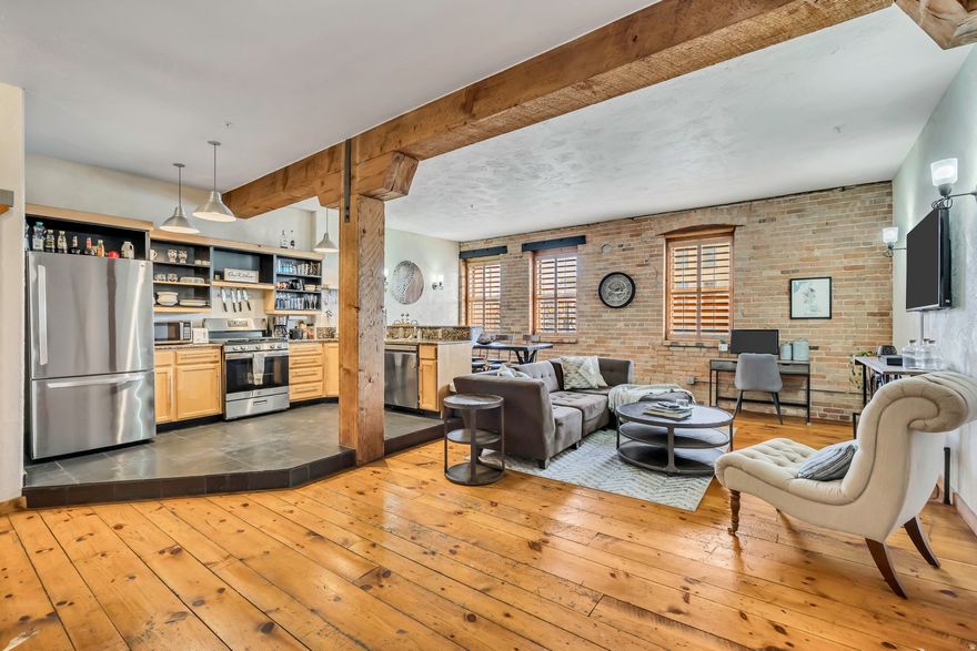 Located in the beautiful, industrial style warehouse building downtown. 1 block from the gateway and Delta Center. Wood beams, brick walls, hardwood floors and an open layout all contribute to this amazing 2 bedroom condo in the perfect downtown location.  9 foot ceilings. Full size washer dryer stack in unit. Large living room, kitchen, dining area, entry way. Gated parking, code access to building. 1 parking spot is reserved and owned for just this unit. NIGHTLY RENTALS ALLOWED. Sold fully furnished and decorated. This unit is well appointed and ready to go! Unit is active as a nightly rental so please text or call agent to schedule showings.