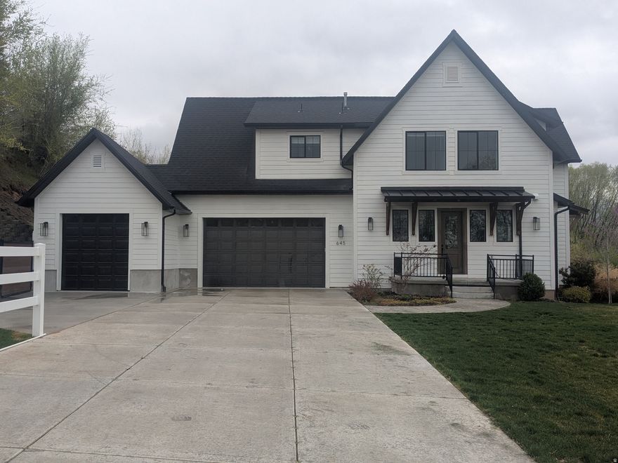 Beautiful newer home on a large lot with numerous custom features. The home is directly across the street from the Spring Acres Arts Park and within close walking distance to Springville High School. The kitchen, living, and dining area work together in an open layout for a big, beautiful gathering area. The home also features a three bedroom, two bathroom basement apartment with a master bedroom and a similarly open and spacious layout. Here are a few other features of the home: large basketball court; in-ground trampoline; bordered by a hill on one side and a year-round brook on the other, with an extra tall privacy fence in the back; garden area; large outdoor patios; custom fireplace; custom, built-in shelves; auxiliary food prep area off the main kitchen; high-end CAF appliances (fridge, stove, dishwasher); office area with custom shelving; vaulted woodplank ceilings; main floor living with a master bedroom, kitchen, etc. on the main floor. There is a fenced, off-street parking area. Square footage figures are provided as a courtesy estimate only. Buyer is advised to obtain an independent measurement.