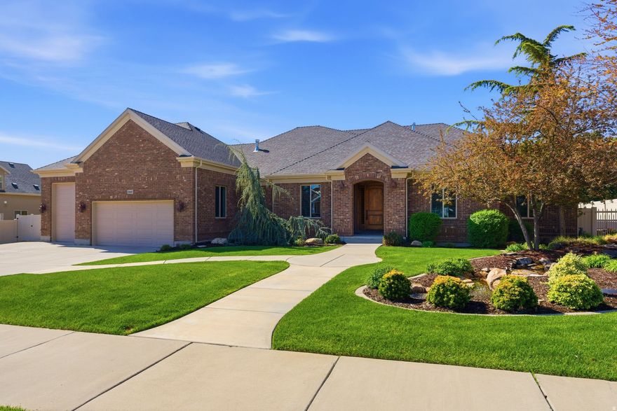 WOW! What a find! This is your opportunity to own a beautifully updated custom rambler in one of South Jordan's most sought-after neighborhoods. From the moment you arrive, the professionally designed landscaping and tranquil water feature with a flowing stream create a true sense of arrival and serenity that sets this home apart. Step inside and be welcomed by an open, light-filled floor plan featuring vaulted ceilings, expansive windows, 8-foot solid alder doors, and a stunning stone fireplace. This home showcases exceptional craftsmanship and timeless design, perfectly suited for both everyday living and elevated entertaining. The chef's kitchen is a true centerpiece, offering a substantial island, extensive custom cabinetry, a copper sink, a generous walk-in pantry, and premium Wolf appliances-seamlessly blending luxury and functionality. The spacious primary suite serves as a private retreat, featuring a jetted tub, walk-in shower, and two large closets, along with direct access to the peaceful, secluded backyard. The fully finished basement offers 9-foot ceilings, a full second kitchen, and a private walkout entrance, providing ideal flexibility for multi-generational living, guest accommodations, or ADU potential. Car collectors and outdoor enthusiasts will appreciate the oversized 4-car garage, including a dedicated RV bay with an oversized door, gas lines plumbed for heaters, and ample vertical space for storage, recreation, or workshop use. Additional RV parking further enhances versatility. Step outside to your own private backyard sanctuary, thoughtfully designed with two gazebos, hot tub readiness, and a second water feature that enhances the peaceful, resort-like atmosphere. This is a rare combination of luxury, space, craftsmanship, and location-all within walking distance to schools, shopping, and dining in a highly desirable community. This gem won't last so, Come and See!