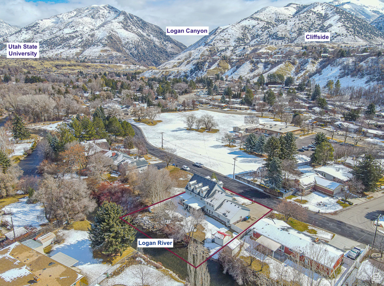 Located in the coveted Island neighborhood, this three-story home offers privacy, space, and natural beauty with the Logan River in your backyard. Enjoy fishing, wildlife, and open space surrounding the property. Featuring main-floor living, ample space for offices, play areas, and entertaining. Large backyard deck, shed, mature trees, fire pit, covered front porch, mountain views and more. With in-floor heating on the main level (including the garage) and forced air heat and a/c on upper levels. Secluded, yet close to everything, it's a rare find that is sure to provide memories for years to come.