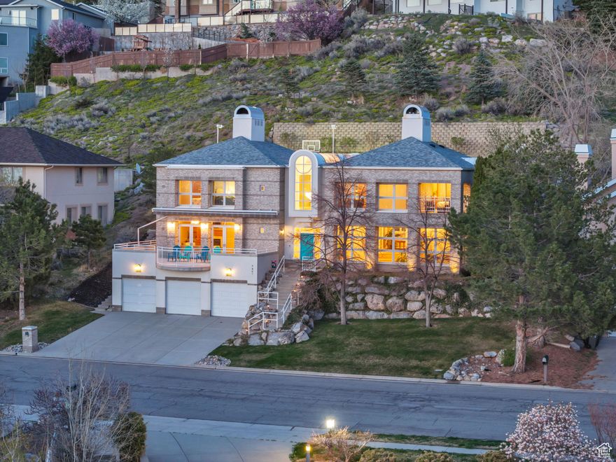 Set high on Salt Lake City's sought-after east bench, this custom-built Scenic Drive home offers spectacular, unobstructed views stretching from the sparkling lights of downtown Salt Lake City across the valley to the peaks of the Oquirrh Mountains. Perfectly perched to capture breathtaking sunsets and panoramic cityscapes, this impressive 5-bedroom, 5-bathroom residence spans over 5,300 sq ft and occupies one of the largest lots (.32 acres) in the neighborhood. Extensively updated (20222024), the home's interior blends timeless craftsmanship with modern amenities. Rich red oak finishes, refinished hardwood floors, heated marble and porcelain flooring, and custom wood-clad windows create an elegant yet welcoming atmosphere. The grand, multi-level entryway immediately impresses with heated marble flooring, sophisticated brass railings, and an exquisite chandelier illuminated softly by a graceful skylight. The thoughtfully designed kitchen is equipped with premium Thermador and Subzero appliances, Corian countertops, custom cabinetry, and a bright breakfast nook seamlessly integrated into the home's living spaces. All five bedrooms are conveniently located on the second level, highlighted by the spacious primary suite, complete with a cozy fireplace, luxurious spa-inspired bath, and private covered balcony offering stunning views of the city skyline and surrounding mountains. Additional bedrooms include thoughtful built-ins, such as a Murphy bed, ample storage, and flexible living space. Flowing seamlessly from the kitchen is the expansive great room, accented by exposed oak beams, features a wet bar and dual French doors opening onto an oversized patio with automatic awning-perfect for entertaining, relaxing, and soaking in the unmatched views of downtown and the entire Salt Lake Valley. The professionally landscaped, tiered backyard further enhances this unique vantage point, offering multiple seating areas, an in-ground spa, half basketball court, and ground-level trampoline, all framed by one of the city's most spectacular panoramas. Additional comforts include radiant heated floors throughout, a finished walk-out basement with extensive storage, and a heated 5-car garage with dedicated workspace. Other unique amenities including a central vacuum, a charming fire pole convertible to an elevator. Ideally situated just minutes from downtown Salt Lake City, the University of Utah, and top-rated schools, this home also offers effortless access to Utah's legendary outdoor recreation. World-famous ski resorts like Alta, Snowbird, Brighton, and Park City are within easy reach, delivering Utah's acclaimed "Greatest Snow on Earth." With Salt Lake City selected to host the Winter Olympics again, this residence places you at the doorstep of Utah's renowned mountain lifestyle and exciting future events.