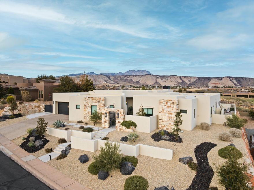 Behind the private gates of The Ledges, this custom home was designed with both tranquility and views in mind. A serene courtyard entry sets the stage for seamless indoor-outdoor living. Perched on an elevated lot, the residence showcases striking red rock panoramas, brilliant sunrises and moonrises, and offers shaded afternoons on the patio beside a dramatic lava rock waterfall. Inside the design is refined yet comfortable.A spacious primary wing creates a retreat of its own, while Restoration Hardware lighting highlights the clean lines and elevated finishes throughout.Vaulted ceilings, expansive windows, and a open layout bring in natural light and frame the desert landscape from every room. Every detail of this home has been thoughtfully curated, creating a one-of-a-kind opportunity to own a true showcase property in The Ledges.