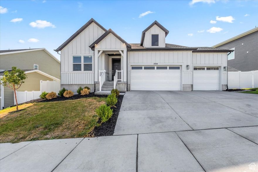 Built in 2022, this nearly new home offers modern style, comfort, and room to grow. The open floor plan features a spacious kitchen, abundant natural light, and a striking fireplace with custom lighted shelving. Remote-control blinds add ease and sophistication throughout the main living areas. Enjoy a beautifully landscaped backyard with a relaxing deck, ideal for entertaining or quiet evenings at home. The garage includes a Tesla charger for added convenience. An unfinished basement provides excellent potential for future living space. Move-in ready with today's most desired features!  Both fridges (garage fridge), the washer and dryer and well as the tesla charger are included. Please make sure to check out HOA amenities.