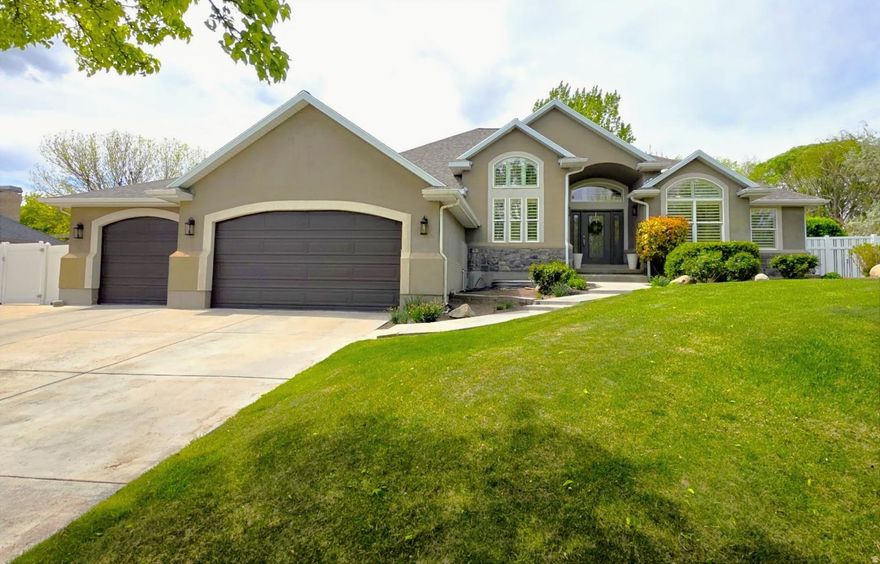 Situated on a rare .50 acre lot in highly desirable South Jordan, this beautifully renovated home offers space, flexibility, and exceptional value. The main level features a large open concept layout connecting the kitchen, dining, and family room, highlighted by vaulted ceilings and premium Taj Mahal quartzite countertops. High end 20 mil lifetime rated LVP flooring runs throughout the home. The walkout basement includes an ADU/mother in law apartment with abundant natural light and a separate entrance, offering flexible use for rental income or multi generational living with 1 to 3 bedroom configurations. Outdoor highlights include a year round stream with water rights that help reduce ongoing water expenses, plus a private fire pit area. The expansive lot provides a prime opportunity for a future shop or detached garage.  Parking is abundant with space for six vehicles in front, secured side access parking behind a swing gate, and dedicated RV parking. The oversized 3.5 car garage offers extra depth for additional storage, workspace, or larger vehicles. An electric dog fence completes this well appointed property combining luxury finishes, functionality, and rare outdoor features.  Buyer and/or Buyer's Agent to verify all information.