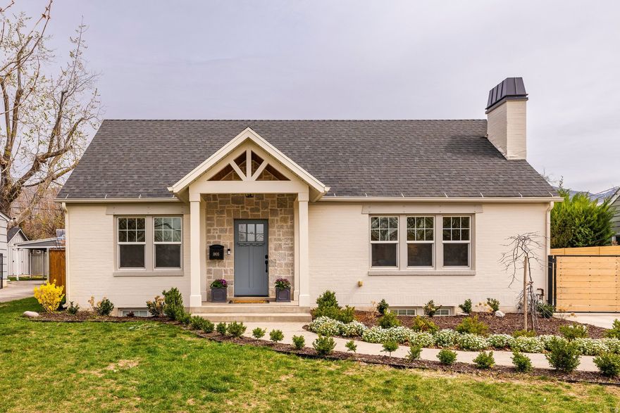 Nestled back off the street on a spacious lot in Sugar House, 1805 South 1900 East has been renovated inside and out. The curb appeal is a standout with a new front porch framed with stone, a newly painted exterior, chimney cap and landscaping. Step inside to an entry with ship lap & hooks and a stately living room with a newer gas fireplace insert, marble tile surround, and bookshelves to anchor the space. Stunning hardwood flooring extends through the main level, complemented by abundant natural light. The bright kitchen flows seamlessly into a spacious dining area with direct access to the back yard, making it perfect for everyday living and entertaining alike. The primary suite has a generous walk-in closet with Classy Closets built-in cabinetry and a professionally designed en-suite bathroom complete with white oak cabinetry, a zero-entry shower, quartz countertops and on-trend tile flooring. With another bedroom on the main floor and another full newly remodeled bathroom, plus a dedicated office on the main level, tucked behind elegant French doors, provides an ideal space for working from home. The lower level features a spacious family room, two additional bedrooms, a bathroom, and a dedicated laundry area. Updates can be found throughout, including brand new carpet, fresh paint, abundant built-in storage, new driveway in 2021, gate & fence 2023, water heater 2025, buried electrical line, and more. Outside, enjoy a spacious backyard with a wooden deck, covered patio with pergola with string lights and shade cover to enjoy the summer evenings, large lawn, and garden boxes. The oversized two-car garage has extra width, depth & height - a rare find in the area. Located in Sugar House, you are just minutes from shopping, restaurants, Sugar House park, and freeway access to the world-class canyons and the Salt Lake International Airport.