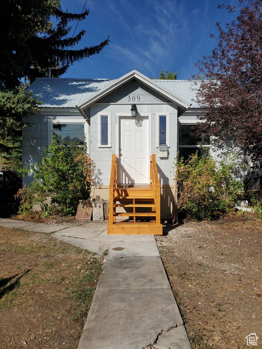 Welcome to 309 South 9th Street!! - Investor Opportunity - This home offers immediate usability, valuable upgrades, and excellent income or workshop potential. This well-maintained property features recent improvements that reduce upfront costs for investors or owner-occupants alike. A thoughtfully updated and well-maintained property offering comfort, functionality, and opportunity to make your own. The home is set on a quiet street with a driveway lined by mature trees, providing a welcoming and picturesque entrance. A wide metal gate allows convenient vehicle access to the backyard and detached garage. Interior updates include new flooring in the kitchen, entryway, and back porch. The furnace and water heater have both been replaced within the past three years, ensuring efficiency and reliability. Additional improvements include new exterior doors, energy-efficient double-pane windows, and updated exterior lighting at the front porch. The detached garage is a major asset and stand out feature: offering an 8x10 overhead door, ample workspace, and a framed-in area for a future bathroom. It is fully insulated, heated with a pellet stove, and pre-wired for a welder- making it ideal for a workshop, rental space, hobby shop or home-based business. Motion sensor lighting is installed on both garage doors, along with a floodlight at the roof peak for added security and convenience. The backyard is private and serene, featuring raised garden beds, a motion-lit chicken coop, and additional space for outdoor activities. For added functionality, the property includes RV parking with a dedicated power hookup and a dump station. This property blends practicality with charm-an excellent opportunity for homeowners seeking both comfort and utility. With functional upgrades already completed, this property is ready for a variety of uses-from rental income to live-work flexibility. Don't miss this versatile investment. Schedule your private showing today.   Square footage figures are provided as a courtesy estimate only and were obtained from _Bear Lake County.  Buyer is advised to obtain an independent measurement.