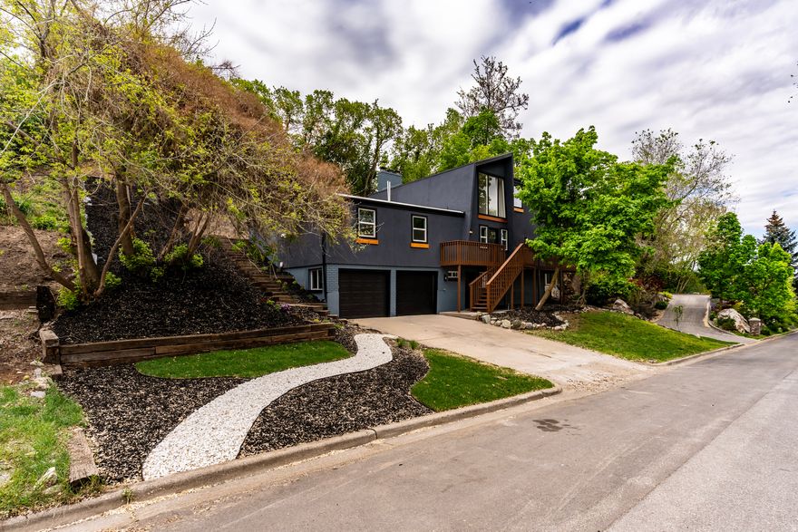 Set in the sought-after Fruit Heights lifestyle, this thoughtfully refreshed residence  delivers a polished, contemporary feel with great views, bright interiors and completely  remodeled, designed to live beautifully. The open main level is centered by a double ceiling  living room area with a showpiece kitchen and abundant cabinetry, flowing into comfortable  living and dining spaces that feel both elevated and welcoming. A versatile lower level provides  room for media, guests, or a home gym, while the expansive unfinished area offers rare  potential for a custom build-out, storage, or hobby/office space. Outdoors, a large entertaining  deck overlooks a terraced, secluded yard with mature greenery-an ideal backdrop for quiet  mornings, sunset gatherings, and the easy elegance of Fruit Heights living. Come see this  masterpiece.