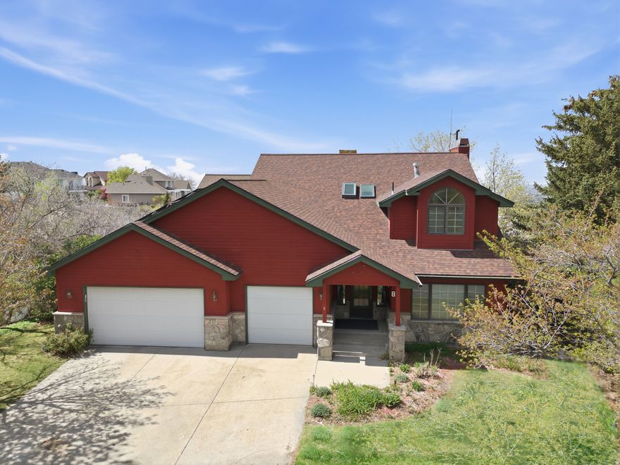 Tucked away on a quiet semi-private lane at the breathtaking mouth of Little Cottonwood Canyon, this exceptional 5-bedroom, 4-bathroom home offers the perfect blend of luxury, comfort, and unforgettable views. From the moment you step inside, you'll be captivated by the warm elegance of rich cherry cabinetry, granite countertops, stainless steel appliances, and beautiful wood flooring that flows throughout the home. The thoughtfully designed main level features a semi-formal dining area, a hidden pantry, main floor laundry, mudroom, and a private office, ideal for both everyday living and entertaining. The stunning great room is the heart of the home, showcasing built-in cabinetry, a cozy gas fireplace, and floor-to-ceiling windows that frame sweeping valley and city views. Step outside to multiple private decks, perfect for relaxing or hosting while soaking in the incredible scenery.  Upstairs, the spacious primary suite offers a peaceful retreat with a walk-in closet and a luxurious en-suite bath featuring a separate tub and shower. Two additional bedrooms and a convenient Jack-and-Jill bathroom complete the upper level. The fully finished daylight basement expands your living space with a large family/media room, kitchenette, full walkout access to a private patio, two additional bedrooms, a 3/4 bathroom, and abundant storage. Outside, enjoy a beautifully landscaped yard with mature trees and a serene sitting area overlooking the valley, your own private escape. Perfectly located just 9 miles from Alta and Snowbird ski resorts, this home offers year-round recreation with hiking and biking trails right out your back door along Little Cottonwood Creek. Step outside and unwind in your private outdoor space, complete with a perfect setting for a hot tub overlooking the valley and city lights below. Additional highlights include a spacious 3-car garage, solar system, ample storage, and top-rated schools.  This home truly has it all. A rare opportunity you won't want to miss!
