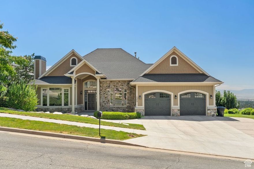 PRICE REDUCED! Nestled in the foothills above Bountiful's coveted Holbrook neighborhood, this 6,656 sq ft rambler on a .59-acre lot captures panoramic lake, mountain, and valley views from every level. Perfect for multi-generational living, a home-based business, or even an Airbnb. The flexible floor plan includes a main-level primary suite, open great room, and chef's kitchen with Thermador gas range, double ovens, and granite countertops. The 2nd level down is another full suite w/ kitchen, large bath, 3 beds, balcony, laundry and garage access. The 3rd level has a walkout basement, and is ideal for a home business, playroom, gym, hosting parties, etc. Multiple decks and patios provide exceptional entertaining areas. Extras include an EV charger, oversized built-in garage with extra height and RV parking, central vac, skylight, and much more. Work, host, and relax all in one stunning East Bench home.