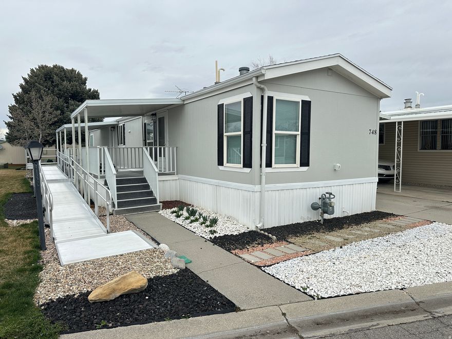 Updated throughout! 2BD/2BA manufactured home in a premier 55+ community-ideal for relaxed, low-maintenance living. Approx. 1,000 sq ft with flexible split-bedroom design perfect for privacy, gatherings, or quiet evenings. Freshly painted & carpeted, modern appliances (fridge, washer/dryer, microwave). ADA-accessible ramp, tidy low-maintenance yard, 2-car parking. Prime central location with easy freeway access, nearby shopping, dining, entertainment, golf, transit & medical facilities. Enjoy peaceful surroundings & mature landscaping in an established senior community. Owner/Broker.