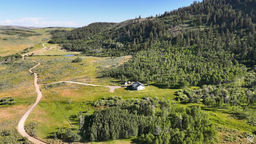 Turnkey Cabin on Acreage with Solar, Well & 2nd Buildable Lot - 2 separate 40 acre parcels sold together - Seasonal county road access 7.2 miles off HWY 36 - 3000+- SF, 2 bedroom, 2.5 bath cabin built in 2001 - Full off the grid capability with solar panels, battery room & Kohler generator - Well, 3 hydrants & 120 gallon buried bladder tank ensuring constant pressure - Panoramic views of Bear River Mountain Range - Winter access requires a snowmachine - Partially fenced - Enjoy expansive canyon views and four season recreation with this high country off the grid cabin tucked in the heart of the Bear River Mountain Range.  Beautifully set against the majestic rolling hills with seasonal access just over seven miles off State Highway 36, this turnkey Stauffer Canyon two bedroom, two and a half bath, 3000 +- square foot cabin is well-maintained and sits on forty acres with an adjacent forty acre parcel providing additional privacy and a potential build site.   The terrain offers endless exploration both on and off the property and opportunities to invite family and friends to set up camp in your own backyard.   The creek and natural vegetation, including wild berries, provide shelter and habitat for wildlife such as mule deer, elk, moose and upland game which frequent the property.  Experience the serenity of the outdoors year-round on the covered front porch and upper covered deck.   The main level front porch is the full lenth of the cabin and offers ample space for greeting guests and seating.  Relax to the gentle sounds of the aspen leaves rustling in the breeze and  enjoy the fresh mountain air.  The stars in the night sky seem to shine especially bright.  Enjoy stargazing without all of the light pollution of the city.    Bear Lake State Park and Marina, known as the Caribbean of the Rocky Mountains for its turquoise blue water, is just thirty three miles away.  Float, fish or swim along the nearby Bear River and return to warm up by the campfire or wood burning stove and enjoy wildlife viewing from the privacy of your own backyard. This is an outdoor recreation enthusiast's paradise with Cache National Forest close by.  Access to miles of dirt roads and trails to explore backpacking, mountain biking, horseback riding, cruising in ATVs, big game and upland game hunting.  Winter access requires a snowmachine and opens the door to a magical winter wonderland to explore snowmobiling, cross country skiing, fat tire biking and snowshoeing.    Equipped with full off the grid capability, including pedestal solar panels, a separate building with battery room and Kohler generator.   The low maintenance fiberglass siding and roof with InsulSafe insulation and partially enclosed upper deck add to the value and peace of mind especially as a recreational property.  In addition to the full bath inside the cabin, a separate plumbed shower house equipped with electricity, water heater, two showers, two sinks and two toilets.comes in handy when hosting guests.  The open floor plan with nine foot ceilings on the main level, a vaulted ceiling on the upper level and natural light streaming in through the windows creates a welcoming glow against the warm wood paneling.  In the fall, the lush evergreen carpeted ridge is particularly vibrant against the golden leaves and white trunks of the aspens.  This may be just the recreational property you have been waiting for.