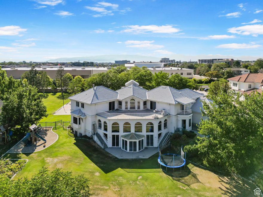 Rare opportunity. Breath taking one acre view lot that overlooks the Provo Valley and Wasatch Mountains.  This home was custom built with superior materials and designed with unique seismic enhancements.  In addition to main floor living, with help of an elevator and extra wide hallways, this home is 100% handicapped accessible.  Features include an indoor pool, elevator, extra large food storage room, home theatre, outdoor sport court, basement apartment, built in sauna, laundry areas on all 3 levels, den with custom birds-eye maple cabinetry, large master ensuite on the main floor, and 4 additional complete ensuites.  Two full kitchens with both up and downstairs kitchens boasting granite counter tops and deep custom cabinets.  Main level kitchen has a 9' island, built in custom desk and large breakfast nook with stunning view of the mountains.  The sprawling yard is fully landscaped with mature trees and plenty of shade.  The fully enclosed backyard hosts a large patio for entertaining, a garden plot for home grown veggies, a large sand box with swing set/fort for children, and a big dog run.  Front yard privacy is ensured by a 6 ft white stucco wall shielding the home from street traffic.  Located in the heart of Provo/Orem, this home is minutes from Provo Canyon, hiking, and skiing, and two universities.  It is walking distance from USPS, VASA gym, restaurants, movie theatres and a major shopping district, yet secluded and quiet on the Orem Rim.