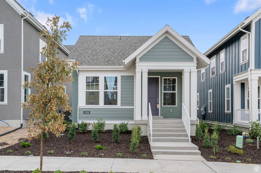 The Baxter Colonial blends timeless design with modern finishes, featuring a stylish kitchen with white laminate cabinets, quartz countertops, a tile backsplash, and platinum gas appliances. Flooring combines laminate hardwood, tile, and carpet for durability and style. Upgrades include can lighting, Christmas light outlets, a tankless water heater, and energy-efficient options. Finishes such as wood stair railing, 2-tone paint, and Craftsman base & casing that adds warmth and character. The owner's suite showcases quartz shower surrounds with satin and brushed nickel hardware for a polished look. All located in a great Daybreak community near schools, parks, common space and more!