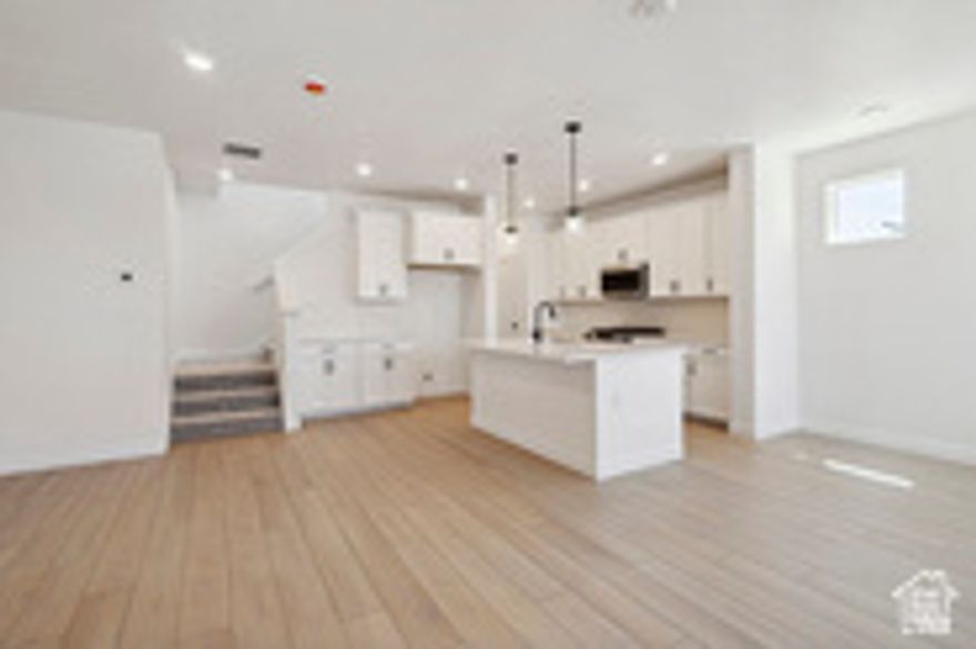 This stunning end residence is filled with natural light and smart design. The chef-inspired kitchen features extra cabinets and workspace, plus everyday convenience with direct garage access-no hauling groceries upstairs. The open-concept main level feels warm and welcoming, perfect for entertaining or relaxing nights in. Unwind in the spacious owner's suite with a large walk-in closet and calming retreat vibes. A flexible loft adds room to work or play, while two additional bedrooms comfortably accommodate family or guests. Thoughtful finishes, energy-efficient features, and the confidence of an award-winning builder's warranty complete the home. Perfectly positioned near scenic parks, shopping, and favorite local dining spots-and just minutes from downtown Salt Lake City and the airport-this location truly has it all. This home isn't just move-in ready, it's ready to move you. PHOTOS of previous home, some finishes may be different.   Square footage figures are provided as a courtesy estimate only and were obtained from plans .  Buyer is advised to obtain an independent measurement.