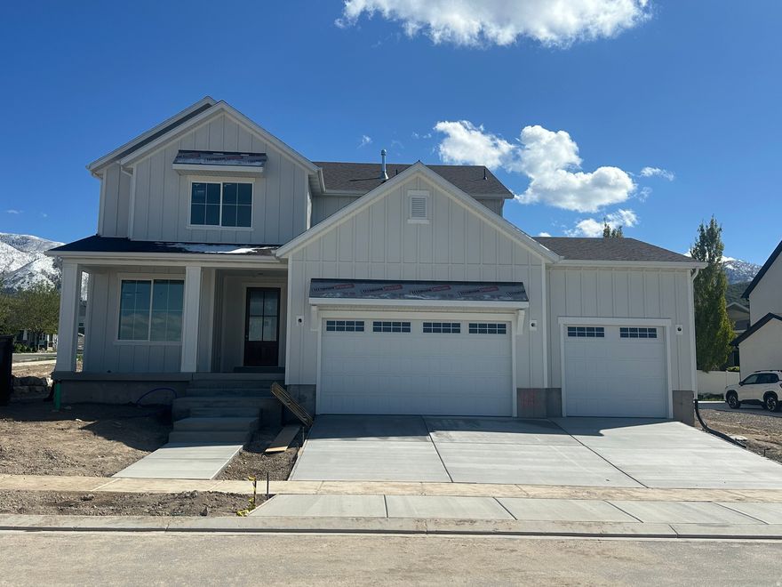 Stunning brand-new 2-story home located in the hills of Elk Ridge. This thoughtfully designed home features a maintenance-free exterior, oversized front door and entry, and a spacious 4-car garage. Enjoy peaceful surroundings from the covered deck. The main level offers an open floor plan with a gourmet kitchen, custom cabinetry, high-end Caf appliances, and double refrigerator/freezer, ideal for both everyday living and hosting. The primary suite includes a luxurious bathroom with double vanity, freestanding soaking tub, oversized walk-in shower, and a large walk-in closet with separate laundry area. Buyer to verify all information. Estimated to be completed by June 2026. Under construction so please call me to set up an appointment. (801) 897-1676