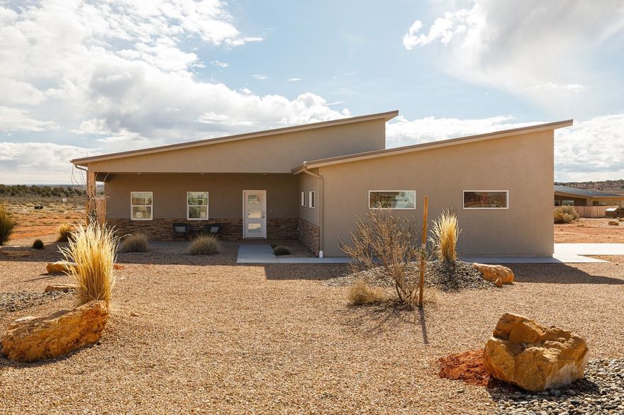 Tucked into the red rock landscape of Kanab, this fully furnished, nightly-rental-approved retreat delivers a rare two-home setup on 2.01 acres-perfect for investors, multi-generational living, or a private getaway that pays for itself. The main home offers 1,813 sq ft with an attached 2-car garage and a bright, open great room designed for gathering and entertaining. Vaulted ceilings, expansive windows, wide-plank flooring, and a clean, modern kitchen create a welcoming space that feels equal parts stylish and comfortable.  The detached casita spans 1,232 sq ft including a 136 sq ft loft, offering a separate living experience ideal for guests or additional rental income. Thoughtful design continues throughout both homes with contemporary bathrooms, tiled showers, and well-appointed bedrooms-each space coming fully outfitted with furnishings and appliances, making this a true plug-and-play investment.  Owners and guests enjoy access to an impressive lineup of resort-style amenities including a large outdoor pool, fire pit for evening gatherings, pickleball courts, and a swing set for kids-adding serious lifestyle and rental appeal. With proximity to Lake Powell, Zion National Park's East Entrance, numerous other parks and travel destinations, endless hiking and biking trails, plus Kanab's beloved dining and art scene, this location checks every box for adventure-seekers and vacationers alike.  Whether you're building a short-term rental portfolio or looking for a flexible property that can host friends and family in style, this turnkey dual-home retreat offers income potential, privacy, and an unbeatable Southern Utah setting.