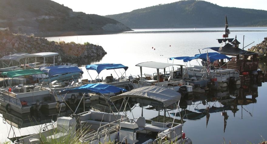 This rare waterfront opportunity at Panguitch Lake offers over 4 acres of prime lakefront property with incredible potential for recreation, investment, or future development. Situated directly on the water, the property includes a private boat dock, several pontoon boats, and related equipment, all included in the sale, creating a unique opportunity for the next owner to continue a long-standing tradition of lake recreation. For years this location was a favorite gathering place where visitors rented boats, hosted family reunions, and created lasting memories at the lake. With the upcoming season approaching, a motivated buyer could potentially have operations ready to go and take advantage of the strong summer demand at Panguitch Lake. The property is zoned for both commercial and residential use, opening the door to a variety of possibilities-from recreational business opportunities to a private lake retreat or future development. The property and all equipment are being sold as-is. Please see agent remarks regarding water shares for a well. Panguitch Lake is one of Southern Utah's most beloved destinations for fishing, boating, ATV riding, snowmobiling, and year-round outdoor recreation, making this a truly special chance to own a piece of lakefront property with both history and potential.