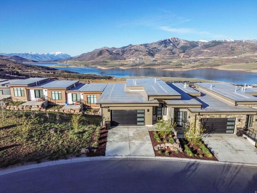 Experience refined mountain living in this exceptional downhill end-unit, perfectly positioned to capture sweeping views of the lake and the iconic Mount Timpanogos. Bordering open space, this residence offers a rare sense of privacy and tranquility, making it an ideal retreat or premier investment opportunity. Offered fully furnished and turnkey, the home seamlessly blends comfort and sophistication. The expansive floor plan features three generously sized bedrooms and three well-appointed bathrooms, complemented by a large chef's kitchen and an open-concept living area designed for effortless entertaining. The primary suite is a private sanctuary, complete with a spacious spa-inspired bathroom and an oversized walk-in closet. The lower level hosts two additional bedrooms, each thoughtfully designed, with direct walk-out access to a secluded outdoor space featuring a hot tub-perfect for unwinding beneath the mountain sky. This is a rare opportunity to own a distinguished property where elevated design meets unparalleled natural beauty. All information is deemed reliable but is not guaranteed and should be independently verified.