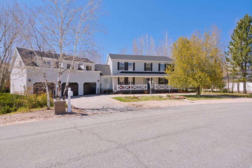 Located in the desirable Wild Willow neighborhood of Kamas Valley, this updated two-story home offers space, flexibility, and mountain lifestyle living just minutes from Park City and endless year-round recreation. Set on .52 acres with mature trees and landscaping, the property features a welcoming front porch, circular driveway, oversized rear deck, and a beautifully secluded backyard with open views toward Francis.  With approximately 4,200 square feet, the property includes 6 bedrooms and 4 bathrooms between the main residence and the private guest apartment above the garage. The main home features a bright, open floor plan with hardwood floors, abundant natural light, and an updated kitchen complete with granite countertops, stainless steel appliances, refreshed cabinetry, tile backsplash, formal dining area, breakfast nook, and an open-concept great room ideal for entertaining and everyday living.  The main residence includes 4 bedrooms and 3 bathrooms, including a spacious primary suite. Just off the kitchen, a flexible multi-use den/game room with sliding barn doors creates the perfect secondary living space, office, or media room.  One of the standout features of the property is the fully equipped private guest apartment above the oversized 3-car garage, offering 2 bedrooms, 1 bathroom, kitchen, living room, dining area, and private laundry-ideal for guests, multigenerational living, caretaker quarters, or potential rental income opportunities.  Additional highlights include new garage doors, new dishwasher and refrigerator and approx. 6-year old roof.  Amazing outdoor private living space, and convenient access to the Jordanelle Reservoir, Mirror Lake Highway, the Uinta Mountains, hiking, fishing, snowmobiling, and all the recreation Kamas Valley is known for.  This home is fully automated and includes ring doorbell system
