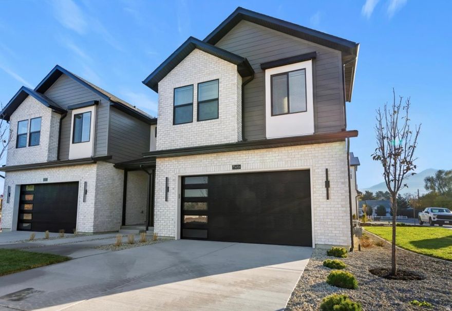 New construction in Trailside Reserve - a modern, low-maintenance community in the heart of Midvale. This stylish twin home lives like a single-family with an open great room, fireplace insert, quartz countertops, and vaulted ceilings. EV-ready garage, private fenced backyard, and HOA-maintained exterior and snow removal for easy living. Virtually staged; photos may vary by unit.