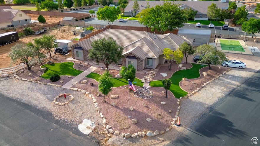 Experience the best of rural living just 10 minutes from St. George in this stunning rambler, perched 1,200 feet higher for cooler summer days. Nestled on 1.03 acres near The Ledges Golf Course and Snow Canyon State Park, this property offers endless opportunities for biking, hiking, and horseback riding. Perfectly set up as a horse property with corrals, it also features a private pool, pickleball court, and boat storage. Inside, the gourmet kitchen boasts built-in double ovens, a spacious hidden pantry, and abundant cabinetry. The full basement includes a second kitchen, craft room, large storage area, and cold storage, ideal for hobbies and organization. With two laundry rooms, this home is designed for ultimate convenience. Whether you're entertaining, relaxing, or enjoying the outdoors, this property offers it all-space, comfort, and recreation in a picturesque setting. Don't miss the chance to make this one-of-a-kind home yours!