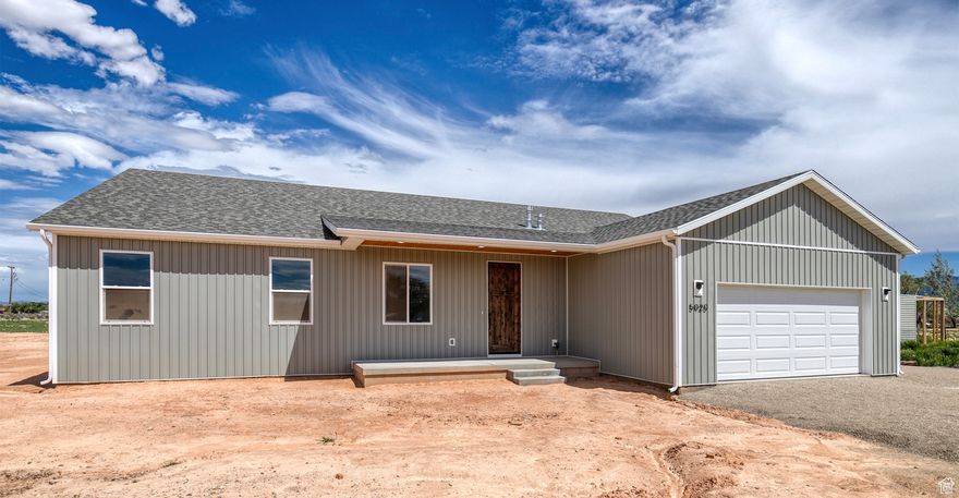 New 4 bedroom/2.5 bath home on 2.5 acres in Cedar City- priced below market value! This home offers 2,450 sqft of comfortable living space- with 9 foot ceilings throughout. You will love the open concept floor plan with kitchen upgrades- who VH  include granite countertops, soft-close cabinets, and a large walk-in pantry. The primary suite has a large walk-in closet, tiled shower, and freestanding tub. Laminate and tile flooring throughout. Enjoy the oversized 2 car attached garage and a 1,000 sqft detached insulated shop/garage with 220v + 110v outlets and 2 garage doors. It also has trailer hookups with water, sewer, and 50 amp electric. A new tool/lawn shed and chicken coop are included- as well as garden beds on drip irrigation and a small orchard. Plenty of space and extras for people who love to work from home, have recreational vehicles, or want to homestead. Come see your new home today!