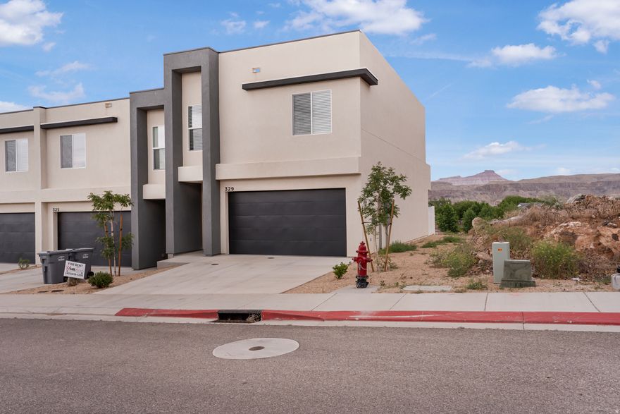 Stunning 4-bedroom, end unit townhome with million-dollar views of Hurricane valley, surrounding mountains and even views of Zion National Park. Seller has priced this unit nearly $15,000 less than other like units in this area. It is only 1 year old and is in amazing condition. You will love the storage throughout the home plus the great attached 2 car garage. You will enjoy the low monthly HOA payment of $50 per month. Don't wait. Call today.