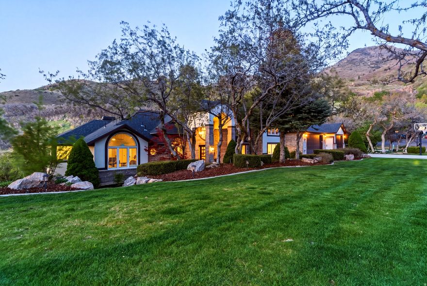 Homes like this rarely come up on Layton's upper bench. Backing directly to Adams Canyon, this extensively renovated home offers unobstructed views, exceptional privacy, and a setting that is difficult to replicate, with no rear neighbors and direct access to the Wasatch Mountains. With approximately $450,000 in upgrades, the home has been updated throughout while maintaining the space and presence of an established property. From the new stucco exterior and front door to updated flooring, molding, and finishes, nearly every major surface has been improved. Natural light pours in through oversized windows, complemented by soaring ceiling heights and a layout that feels open and comfortable. The kitchen features high-end appliances, a generous workspace, and seamless flow into the surrounding living areas. The main level includes a spacious primary suite along with an additional ensuite bedroom that works well for guests or a home office, offering flexibility that is hard to find. The outdoor setting is what truly separates this property. The yard offers a rare combination of usability and privacy for the upper bench, with a park like feel and space to relax or entertain. A newly built deck extends the living space and captures views of Antelope Island and the Great Salt Lake, while sitting at the base of the mountains. Direct access to hiking and mountain biking trails, including the Bonneville Shoreline Trail and the full canyon trail network, places one of the area's most well known waterfall hikes within easy reach from your back door. A large storage area beneath the garage provides space for tools, gear, and recreational equipment without giving up garage functionality. Convenient access to nearby amenities, commuter routes, and a community pool round out the setting.  All property information, boundaries, and documents to be verified by the buyer.