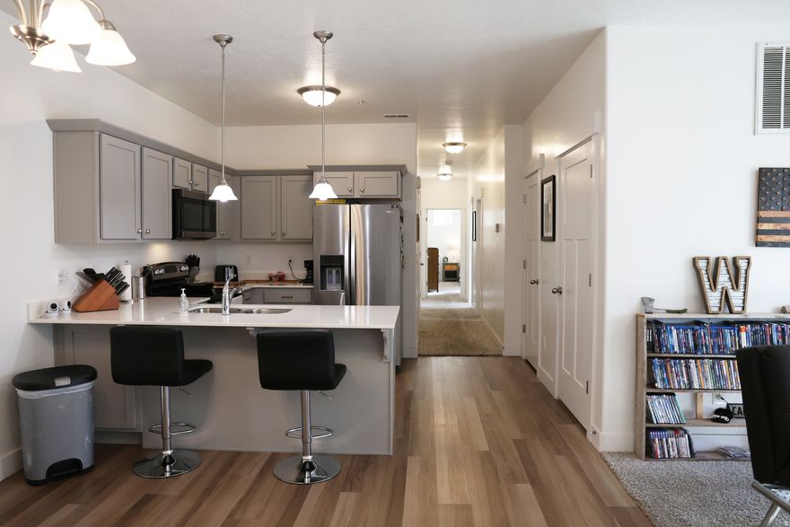 Beautifully maintained second-floor condo with a rare private garage. 3 bed, 2 bath, quartz countertops, refrigerator included. Brand-new water heater (2026). Middle-unit location helps with lower utilities and winter heat retention. Cabinet hardware added to reduce wear. Community clubhouse, pickleball courts, parks, playgrounds. Close to I-15 and Redwood Rd. Designated additional parking. Lower HOA in the area-compare other listings.