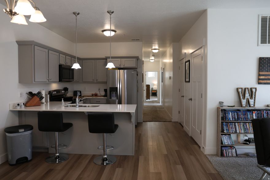 Beautifully maintained second-floor condo with a rare private garage. 3 bed, 2 bath, quartz countertops, refrigerator included. Brand-new water heater (2026). Middle-unit location helps with lower utilities and winter heat retention. Cabinet hardware added to reduce wear. Community clubhouse, pickleball courts, parks, playgrounds. Close to I-15 and Redwood Rd. Designated additional parking. Lower HOA in the area-compare other listings.