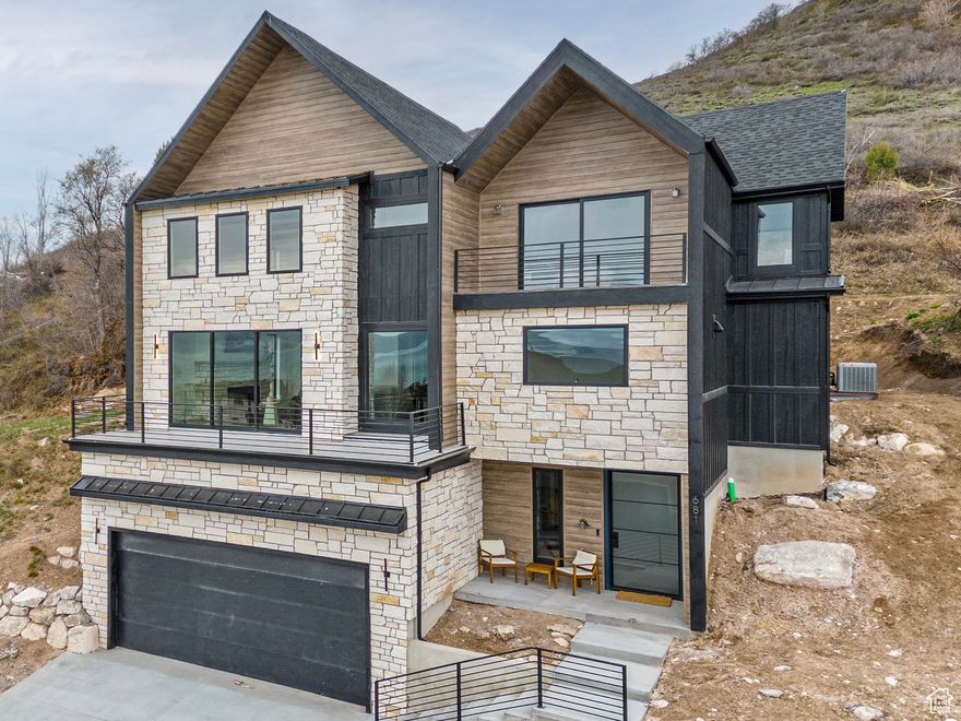 Luxury Bear Lake Retreat with Panoramic Views, Fully Furnished & Turnkey!  Perched above Bear Lake in the heart of Garden City, this home combines thoughtful design, top-tier finishes, and breathtaking views in every direction. Floor to ceiling windows and two-story vaulted ceilings anchor the main living space, with a sleek linear fireplace and a multi-sliding panoramic door that opens to a large deck overlooking the lake, mountains and stunning sunsets!  The kitchen is built for gathering and entertaining, featuring a large waterfall Calcutta quartz island, custom cabinetry, and a large walk-in pantry. A floating staircase with built-in accent lighting leads upstairs to a reading nook, where every detail of the home has been designed for comfort and style with specialized tile and high end finishes throughout.  With 6 bedrooms and 5 bathrooms, including 3 en-suites, there's room to comfortably host large groups. The home sleeps 22+ guests, highlighted by a custom bunk room with professional built-ins, a dedicated theater room, and a primary suite with its own private deck and unobstructed lake views.  Sold fully furnished, this property is truly turnkey and already a proven performer! Fully rented throughout the summer and ideal for anyone seeking a high-return short-term nightly rental or multi-family vacation home.  Outdoor living is just as inviting with a massive deck designed for entertaining and access to a private clubhouse and pool. From here, you can walk to the marina, grocery store, and local restaurants placing everything Bear Lake offers right at your doorstep making this a gem of a location!   Enjoy all four seasons! Vibrant summer events like Raspberry Days, Bear Lake Winterfest, Beaver Mountain Ski Resort and sledding hills just minutes away!   This is more than a home, it's a year-round retreat blending luxury, location, and investment potential in one of Utah's most sought-after destinations.