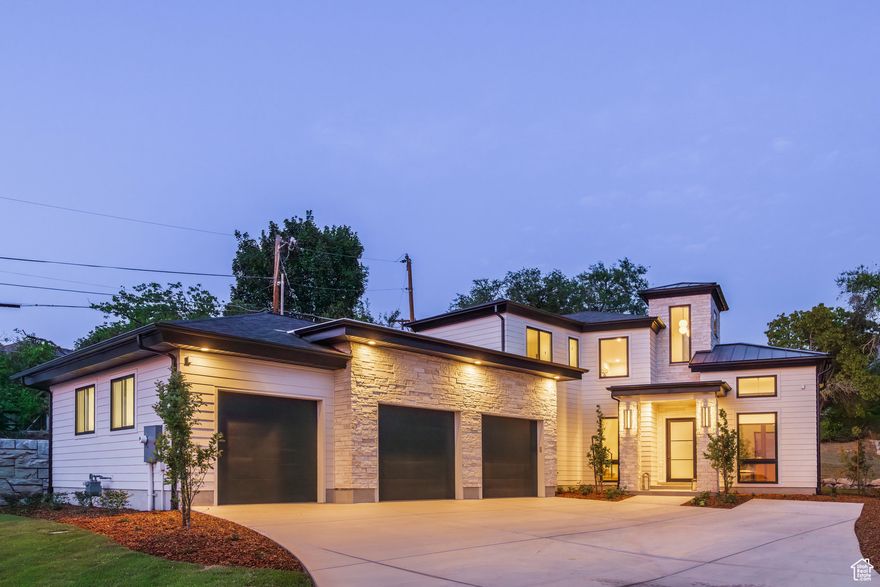 Experience modern luxury and exceptional design in this contemporary new build by Holmes Homes. Nestled in a quiet East Millcreek cul-de-sac surrounded by custom homes, this residence offers a rare blend of privacy, sophistication, and low-maintenance living in one of the valley's most desirable neighborhoods. The thoughtfully designed lot maximizes every inch of outdoor space with a series of private patios extending from the dining area, living room, kitchen, and primary suite, perfect for morning coffee, quiet relaxation, or effortless indoor-outdoor entertaining. Custom fencing offers maximum privacy on the side yard with a private, shady backyard with room to expand by adding retention walls. Inside, a welcoming entry opens to a refined receiving room and an expansive, open-concept layout. Soaring ceilings and oversized windows create an airy ambiance, while the transitional design balances clean, modern lines with timeless comfort. The main level offers ideal functionality with a chef's kitchen, walk-through butler's pantry, informal dining, and a spacious great room with access to the grounds on both sides. Enjoy main-level living with a serene primary suite featuring a private deck and walk-in closet, plus a sunny laundry room and a well-appointed mudroom off the 3-car garage. Upstairs, you'll find a versatile loft, a second suite, and two additional bedrooms connected by a Jack and Jill bath, ideal for guests or family alike. Located near top-rated schools, parks, dining, and outdoor recreation, this property offers a rare opportunity to own a thoughtfully crafted modern home in one of Salt Lake's most coveted locations.