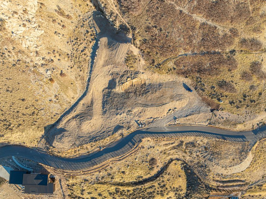 This new gated community is located high on the mountain side above Foothill Boulevard. The views are incredible and the location ensures quick access to everything. The owners of this choice, large lot combined three into one...resulting in a very large, flat plateau at center, a geographically beautiful cove in back, and simply breathtaking city, valley and sunset views out the front. There will be no neighbors in the views...ever! The building plateau is nicely elevated just above the street for total privacy. Non-buildable open space in back offers hiking opportunities. Unique and rugged rock formations add to the excitement. This is most likely one of the very best building sites in all of Salt Lake!     Professional move forces sale of a dream home almost ready to begin just after groundbreaking.  Photo renderings are copyrighted by CLB Architects with credit to CLB Architects, Design Workshop and Notion Workshop.  Buyer will need a relationship with CLB Architects to finalize these plans.