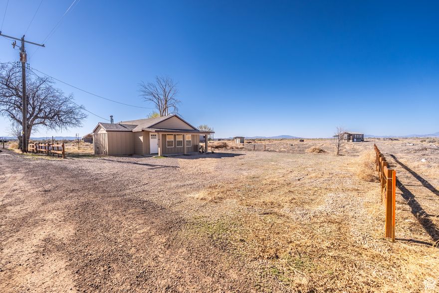 This is the one you've been waiting for-an unbeatable opportunity that checks every box! Nestled on 5 acres of endless potential, this unique property includes an ADU-perfect for multi-generational living, rental income, or your next big dream. Water rights included!  Both the main home and ADU boast updated flooring, kitchens with newer cabinets, granite countertops, backsplash, and renovated bathrooms. Each home includes a refrigerator, washer, and dryer. The main home offers a cozy fireplace, while the ADU provides generous additional living space for guests, family, or extra income potential.  Plenty of room for animals, gardens, or workshops-live the country lifestyle you've always dreamed of.  Live, rent, build, or invest-this property has it all. Don't miss your chance-schedule your showing today!  Square footage figures are provided as a courtesy estimate only and were obtained from appraisal. Buyer is advised to obtain an independent measurement.