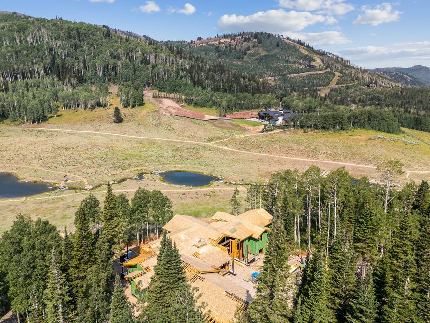 This private custom ski-in/ski-out home is currently under construction and expected to be completed Fall of 2026. It's nestled within The Colony at White Pine Canyon, an exclusive guard-gated residential neighborhood consisting of large acreage lots with direct ski and snowboard access to the Nation's Largest Ski Resort. The legacy ski resort home of your dreams, this floor plan spans over 11,600 sq ft and promises the perfect mix of comfort and luxury with plenty of indoor and outdoor living areas for unparalleled enjoyment and ample space for hosting and entertaining family and friends. Surrounded by natural beauty, this residence is a haven amidst the trees, offering breathtaking views of the mountains and ski runs as well as the enchanting ponds, all visible from the comfort of your luxurious retreat.
