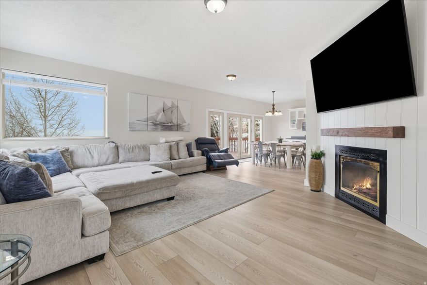 Experience the "Caribbean of the Rockies" from this stunning 4-bedroom, 3.5-bath retreat in the heart of Garden City-now more desirable than ever thanks to its exceptional proximity to the expanding Bear Lake State Park Marina. With increased capacity, improved amenities, and growing demand for slips and lake access, owning nearby has become a true competitive advantage-and purchasing now is a smart way to beat the crowd. Spanning nearly 3,000 square feet, the home features two spacious living areas and a recently remodeled interior, including a refreshed gourmet kitchen designed for effortless hosting. The property is uniquely framed by mature aspen and pine trees, offering the rare combination of shaded privacy and sweeping views-shimmering turquoise waters of Bear Lake paired with dramatic mountain silhouettes. Unlike many hillside properties, this home offers a rare, long and flat driveway with an attached 2-car garage, ensuring easy year-round access and ample space for boats and toy trailers-ideal for frequent marina use or quick trips to the Bear Lake Valley's snowmobiling areas. The property also includes a separate, buildable lot with a fully landscaped yard, providing flexibility for a future second home, guest residence, or long-term investment (second lot parcel ID: 41-17-030-0046). Whether you're heading to the marina for a day on the water, grabbing a shake in Garden City, or driving just 20 minutes to Beaver Mountain for winter skiing, this location delivers unmatched convenience. Ideal as a primary residence or a high-performing vacation rental, this home represents a rare opportunity to secure a premium position near Bear Lake's most sought-after waterfront access-before demand fully catches up.  Square footage figures are provided as a courtesy estimate only. Buyer is advised to obtain an independent measurement.