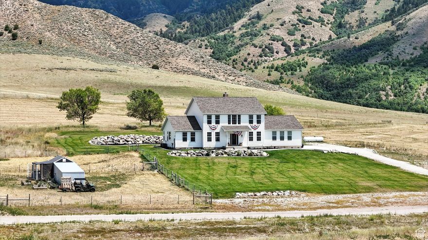 Stunning newer construction located in the highly sought-after New Canyon area just north of Malad, Idaho, offering breathtaking mountain and valley views with the perfect balance of privacy and convenience-only minutes from I-15. Built in 2021, this spacious two-story home offers approximately 3,500 sq ft, 4 bedrooms, and 5 bathrooms, with the potential for up to 6 bedrooms by adding closets. Designed for modern living and remote work, the home features fiber internet and CAT-6 ethernet throughout. The vaulted entry welcomes you into a large, light-filled living room with a cozy fireplace, flowing seamlessly into a gourmet kitchen complete with an oversized island, premium range, two dishwashers, wood-burning stove, and expansive picture windows that capture the surrounding scenery. Thoughtful functionality includes two laundry hookups, one conveniently located in the primary suite's walk-in closet. Situated on 4.6 acres, the fully landscaped exterior is equally impressive, featuring water spigots and power run to a large shed, fenced area, and two chicken coops (white and black). A professionally leveled 40x70 pad is already in place-ready for a future shop or additional outbuilding. Additional upgrades include a tankless water heater, kitchen sink water purification system, remote-controlled roller shades, and the refrigerator, barn, and chicken coops are included-making this property truly move-in ready and ideal for animals or livestock. Why wait to build when you can own a nearly new home in one of Malad's most scenic locations? Buyer to verify all information.