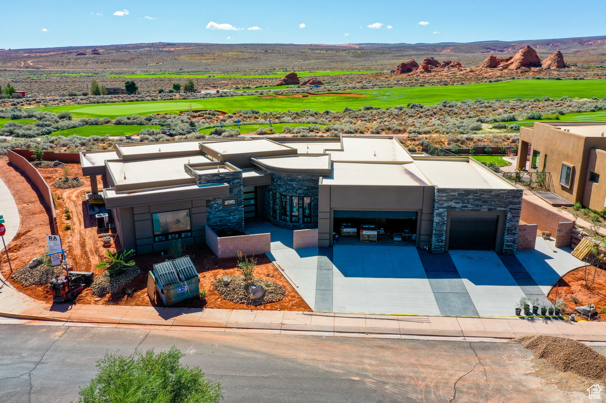 Discover unparalleled luxury in this 5-bedroom, 5-bathroom, 4,215 SF custom home, perfectly nestled between the 9th green and 10th fairway of the world-renowned Sand Hollow Golf Course. Designed by Allen Key Development, this .35-acre sanctuary captures breathtaking golf course and mountain views, blending elegance, innovation, and comfort. Step into a grand entry with a striking 5' x 9' pivot glass door, leading to a designer kitchen featuring Thermador appliances, two wall ovens (one with Home Connect smart technology), a Zephyr vent hood, soft-close cabinetry, and a glass-door beverage cooler. The hidden pantry and prep area elevate functionality, while the private ADU, complete with a mini kitchen, washer/dryer hookups, and separate HVAC-offers versatile living options. Indulge in spa-inspired bathrooms, with the primary suite boasting a sauna, quartz transparent shelf with integrated lighting, and an elegant makeup bench. Two fireplaces, an electric one in the primary bedroom and a gas fireplace in the great room, create a cozy ambiance. Zoned HVAC with dual units ensures tailored comfort, while Anderson windows, 2x6 framing, R49 insulation, and sound-dampening walls prioritize energy efficiency and tranquility. Outside, the pool-ready backyard with gas stub for a BBQ, fully fenced yard with sleek metal railing, and a finished courtyard with built-in seating invite seamless outdoor living. The extra-wide 3-car garage includes a 37' deep tandem bay-ideal for dual vehicle storage, gear, or workspace. The premium epoxy flooring offers long-term durability, low maintenance, and a polished look that elevates the space, while the solid Martin doors add architectural elegance and enduring quality. With dual 220V EV charging outlets, this space is not only refined, it's future-ready. Fiber internet-ready conduit ensures modern connectivity. Located minutes from Sand Hollow Reservoir for water sports and thousands of miles of off-roading trails, this home is an adventurer's paradise. Ranked among Golf World's Top 100 Courses, Sand Hollow's dramatic red-rock cliffs and vibrant greens create a stunning backdrop. Enjoy a transferable builder's warranty and a personalized orientation upon sale for ultimate peace of mind. This is more than a home-it's a lifestyle of luxury and adventure. POOL IN 3D MODEL/VIDEO IS NOT INCLUDED