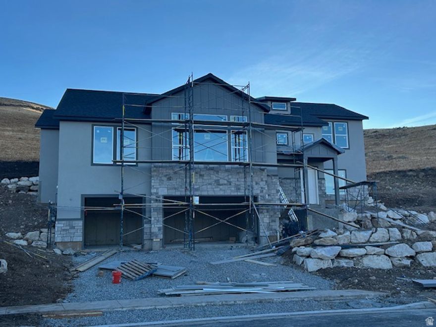 Unmatched views from every window in this hillside raised rambler with generously-sized rooms - live the "top-of-the-bench lifestyle" right adjacent to hiking/biking trails into the mountains and only a 35 minute drive from SLC International Airport!  The Great Room area is perfect for entertaining and large gatherings.  The rear covered patio is perfect for solitude and mountain views.  White Cabinetry with dark hardwood accents and granite countertops.  Due to be finished January 31st 2026.  Taxes are an estimate as this home is new and has never been assessed before.