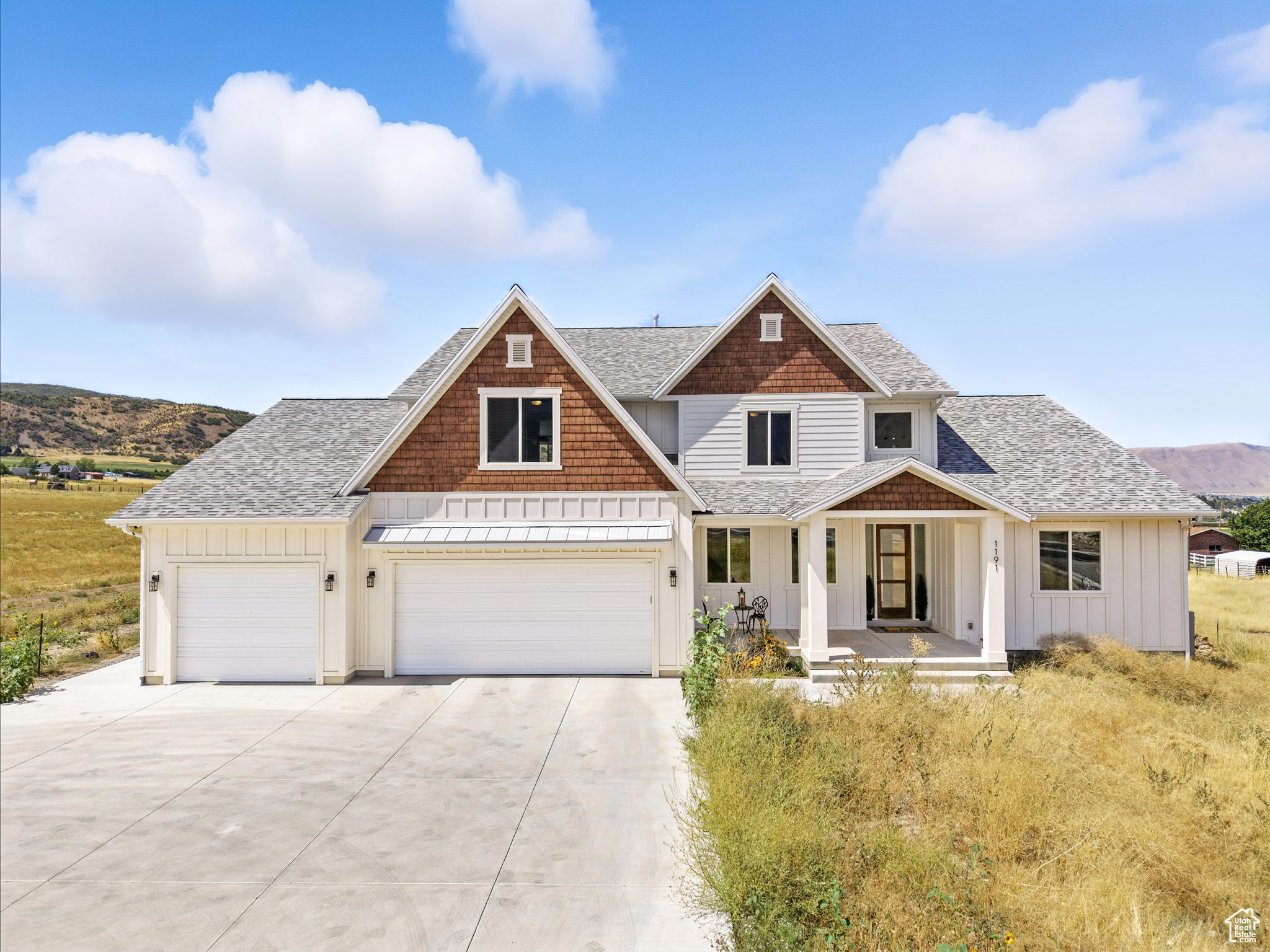Be sure to click "Tour" for a 3d home walk through! From the moment you arrive, this home greets you with quiet privacy, set 150 feet back from the road, where peaceful surroundings and expansive mountain, valley, and lake views stretch out in every direction. Step through the wide entry and into soaring 19-foot ceilings in the living room, where walls of windows flood the space with natural light and frame sunsets that will take your breath away. The open floor plan connects everything together-the kitchen, dining, and living area flow seamlessly so you're always part of the conversation. At the heart of it all is the largest quartz island possible from a single slab-over ten feet long and five feet wide-designed for gathering, cooking, and creating memories. The island houses your Bosch induction cooktop and a Zephyr motorized downdraft for the stove that disappears seamlessly into the counter when not in use. Surrounding it, high-end Bosch convection ovens with side-opening doors, a microwave in the kitchen and another in the pantry, and two stainless steel KitchenAid dishwashers that actually clean your dishes make every meal effortless. Custom Italian TSV cabinetry, a massive walk-through pantry with extensive custom shelving, and space for two fridges, a chest freezer, and even a direct garage entry for bringing in groceries with ease mean the kitchen is as functional as it is stunning. On the main level, your 17' x 39' owner's suite is more than a retreat-it's a sanctuary. With its own sitting area, oversized shower, soaking tub, and attached 17' x 13' office, your days begin and end with comfort and sweeping views of the entire valley, Utah Lake, and the mountains-scenes that few ever get to call their own. Upstairs, your 850-square-foot loft overlooks the family room below and opens to a second-level covered deck with ceiling fans-the perfect perch to take in the valley views. Every detail is designed for living well. Extra-wide stairs designed for comfort, flow, and ease of living, smart blinds that respond to Alexa or Google, energy-efficient LED lighting, and a whole-house fan that cuts cooling costs by up to 90%. The laundry room takes convenience further with custom cabinetry, quartz countertops, laundry basket stations, and raised bases for the washer and dryer. Step outside to to the covered front porch, or gather on your expansive covered back patio with ceiling fans and space for grilling and dining. From there, stairs lead down to your private 90' x 90' grass field-big enough for soccer games (complete with an outdoor drinking fountain), reunions with friends, watching an outdoor movie, or simply enjoying the sunset by a fire with your loved ones. With a separate two-bedroom apartment complete with its own full kitchen and laundry-perfect for multigenerational living or income potential, massive parking, a mudroom designed for everyday life, 400-amp electrical service and 2 lb. gas service provide ample capacity for you to add a pool, spa, gas-heated workshop, additional HVAC, and any upgrade you envision, and one of the quietest, most serene settings in the county, your home is more than a place to live-it's where life expands. (Please note that 2 of the 5 bedrooms, and a full bathroom are in the accessory apartment which is not pictured on the 3d Tour)