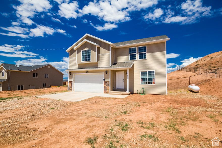 Beautiful 2-Story Home in Ballard, UT!  4 bedroom, 2.5 bath, Stunning Backdrop View of the surrounding red cliffs!  Quiet and beautiful area close just 5 minutes away from a lot of shopping amenities, Huge fully fenced backyard, no neighbor on the right hand side, interior has some nice upgrades with granite countertops and brand new Luxury Vinyl Flooring upstairs in a second living room, Tonz of parking space and great home for a good sized family. Don't miss this beautiful home!