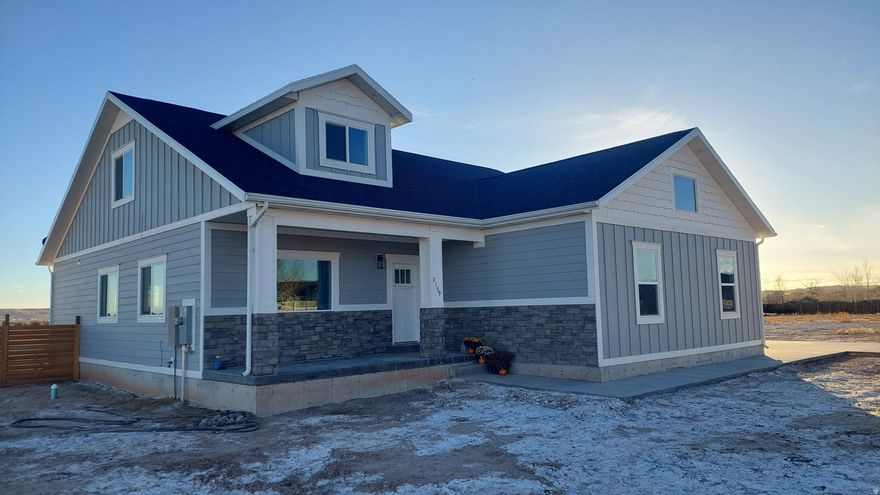 Modern 2-Story Home on 1.05 Acres!  Built in 2022, this beautiful single-family home combines modern comfort with timeless design. Featuring stone and cement board siding, double-pane windows, and an open front porch, it's move-in ready and built to impress. Inside, enjoy an open-concept layout with granite countertops, a pantry, a private den/office, and a spacious primary suite with a walk-in closet and ensuite bath.  Energy-efficient forced-air propane heating (95%), central air, and fiber internet ensure year-round comfort and convenience. The oversized 2-car deep tandem garage offers ample storage and workspace. Set on a flat 1.05-acre lot, there's plenty of room for outdoor living, gardening, or future expansion.