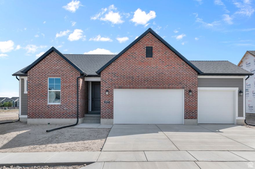 This thoughtfully designed 1350 Garden home combines charm, efficiency, and modern style. The kitchen features white laminate cabinets, sleek quartz countertops, and stainless steel gas appliances, highlighted by a bay box window in the nook that adds natural light and character. The open living areas are enhanced with laminate hardwood, tile, and carpet flooring, along with can lighting and 2 tone paint for a clean, contemporary finish. The owner's suite offers a relaxing retreat with its own bay box window and an owner's bathroom with cultured marble shower surrounds and black matte hardware accents. Additional upgrades include a 3-car garage with keypad and exit door, metal railing at the stairway, Craftsman base & casing, and Christmas light outlets for year-round convenience. Built with a tankless water heater and energy-efficient options, this home blends comfort with sustainability in a modern Craftsman-inspired design. All in a sought after Lehi community near parks, schools and shopping.