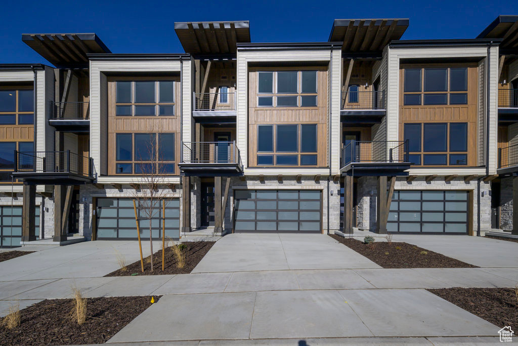 Discover The Pointe at Current-where sleek modern architecture meets the serenity of mountain life. Nestled between Park City and Heber City, this thoughtfully designed townhome is perched on the western edge of Jordanelle Reservoir, offering the perfect blend of elegance, efficiency, and adventure. Step outside and you're moments away from scenic hiking and biking trails, world-class ski destinations, and a full range of lake activities throughout the year. A convenient private underpass beneath SR-450 gives you effortless access to Deer Valley Resort, so your next mountain day is always just around the corner. Crafted to Garbett Homes' signature Efficiency+ standards, this home delivers superior comfort and sustainability. Expect exceptional insulation, Solar-E windows, and an advanced air-recirculation system that enhances natural light, regulates temperature, and helps reduce monthly energy costs. Inside, modern design meets everyday functionality-featuring quartz countertops, custom cabinetry, and durable high-performance flooring. Relax on your private balcony overlooking panoramic mountain vistas or retreat upstairs to two primary suites, each offering a peaceful getaway. The grand suite includes its own private deck-ideal for soaking in Utah's alpine beauty. With no HOA restrictions on nightly rentals, this property offers incredible flexibility-whether you're seeking a full-time residence, a second home, or an investment opportunity. Ask about current buyer incentives available through our preferred lender!