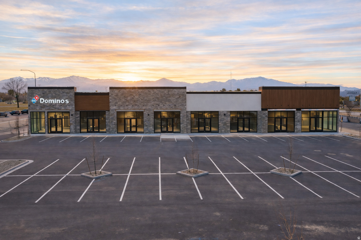 View of commercial property with a mountain view and uncovered parking