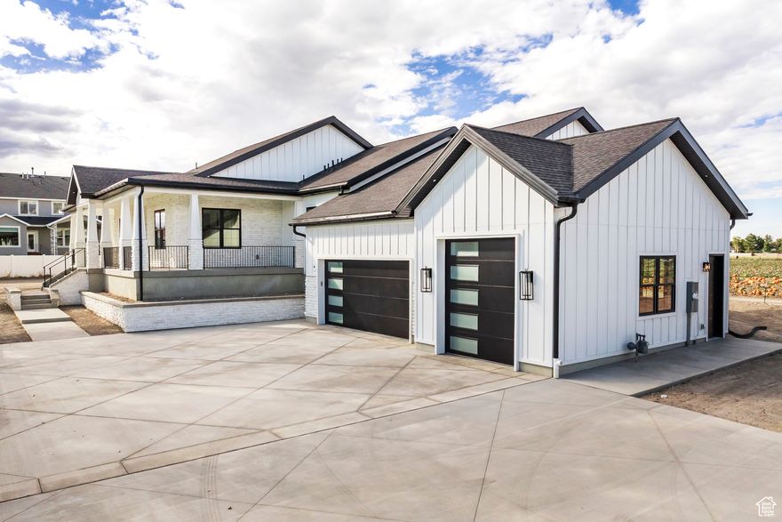 Discover this beautifully crafted 5-bedroom, 3.5-bath custom rambler tucked away on a private road in the heart of South Jordan. Perched on a generous .45-acre lot, this residence is designed for both elegance and everyday living, with elevated ceilings, abundant natural light, and custom cabinetry throughout. At the heart of the home, the gourmet kitchen features a premium Thermador appliance package, a spacious butler's pantry, and seamless access to the open-concept dining and family areas. From here, step onto the expansive deck and take in majestic views that stretch across every corner of the property. The walkout basement extends the home's entertaining potential, offering a large patio perfect for a hot tub, gatherings, or simply soaking in the scenery. Additional highlights include a 3-car garage with a 10' door on the third bay, ideal for boats or lifted vehicles, along with a wrap-around patio, oversized cold storage (perfect for a wine cellar or safe room), and ample space for outdoor recreation or future additions. Minutes from parks, schools, shopping, and freeway access, this rare retreat delivers the ultimate balance of luxury, privacy, and convenience, perfect for those seeking both peace and connection.