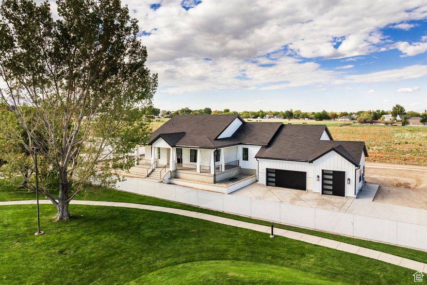 Discover this beautifully crafted 5-bedroom, 3.5-bath custom rambler tucked away on a private road in the heart of South Jordan. Perched on a generous .45-acre lot, this residence is designed for both elegance and everyday living, with elevated ceilings, abundant natural light, and custom cabinetry throughout. At the heart of the home, the gourmet kitchen features a premium Thermador appliance package, a spacious butler's pantry, and seamless access to the open-concept dining and family areas. From here, step onto the expansive deck and take in majestic views that stretch across every corner of the property. The walkout basement extends the home's entertaining potential, offering a large patio perfect for a hot tub, gatherings, or simply soaking in the scenery. Additional highlights include a 3-car garage with a 10' door on the third bay, ideal for boats or lifted vehicles, along with a wrap-around patio, oversized cold storage (perfect for a wine cellar or safe room), and ample space for outdoor recreation or future additions. Minutes from parks, schools, shopping, and freeway access, this rare retreat delivers the ultimate balance of luxury, privacy, and convenience, perfect for those seeking both peace and connection.