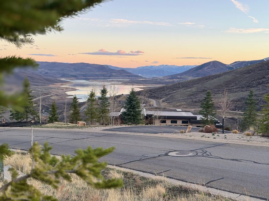 Deer Vista, where the mountains set the rules, the sky feels bigger than your plans and daily life bends around access to the outdoor playground! Sweeping panoramas of Jordanelle Reservoir and Deer Valley's ski runs unfurl from this rare 1.38-acre south-facing, uphill homesite in the gated enclave, where your home will sit elevated above its neighbors with unobstructed mountain and lake views from every window. Positioned in one of the most beautifully curated mountain neighborhoods in greater Park City - just 6 minutes to Deer Valley East Village and 12 minutes to Old Town - Lot 22 offers both the scale and the orientation that serious builders covet. With a gentle uphill pitch, the site allows you to command the ridgeline rather than follow it. ARC-approved architectural plans valued around $80,000 are included in the purchase price, to the buyer, offering a meaningful head start. Deer Vista's 103 custom homesites spread across 400 acres mean the density never intrudes, only the trails, the views, and the neighbors who chose this neighborhood for the same reasons you will. A community park, Black Rock Mountain Resort access, and a vibrant social calendar round out a lifestyle that is equal parts adventure and ease. This is the lot you build your forever home on, because there isn't another one like it. The Salt Lake International Airport is approximately 45 min away or fly in privately to the Heber Valley Airport which is 20 min away