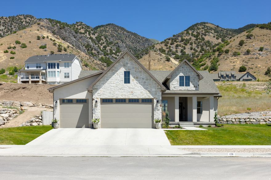 Welcome to an exceptional NEW CONSTRUCTION opportunity in one of Providence's most prestigious east bench neighborhoods. Situated on a rare and expansive .53-ACRE LOT, this beautifully designed 3,271 sq ft home offers the perfect blend of luxury, functionality, and timeless style.Built by Duke Building Co, a respected custom builder known for superior craftsmanship and a seamless building experience, this home is thoughtfully curated from start to finish using top-tier subcontractors and high-quality materials throughout. Step inside to discover a bright, open-concept layout featuring Luxury Vinyl flooring across the entire main level, creating both warmth and durability. The stunning kitchen is a true centerpiece, showcasing painted custom cabinetry, quartz countertops, and a hidden pantry-perfectly designed for both everyday living and entertaining. With 5 spacious bedrooms and 3 beautifully finished bathrooms, this home offers flexibility for families, guests, or a dedicated office space. The 3-car garage provides ample room for vehicles, storage, and recreational gear.Every detail has been carefully considered, from the elegant tile work in bathrooms to the refined blend of stone and stucco exterior, delivering striking curb appeal that complements the surrounding landscape. Located on the highly sought-after Providence East Bench, you'll enjoy breathtaking mountain views, a peaceful setting, and convenient access to trails, schools, and amenities-truly one of Cache Valley's most desirable areas. If you've been dreaming of building a custom home without the stress, this is your opportunity to partner with a builder who delivers excellence every step of the way. THERE'S NOTHING LIKE A BRAND-NEW HOME-MAKE THIS ONE YOURS AND START LIVING YOUR DREAM TODAY.